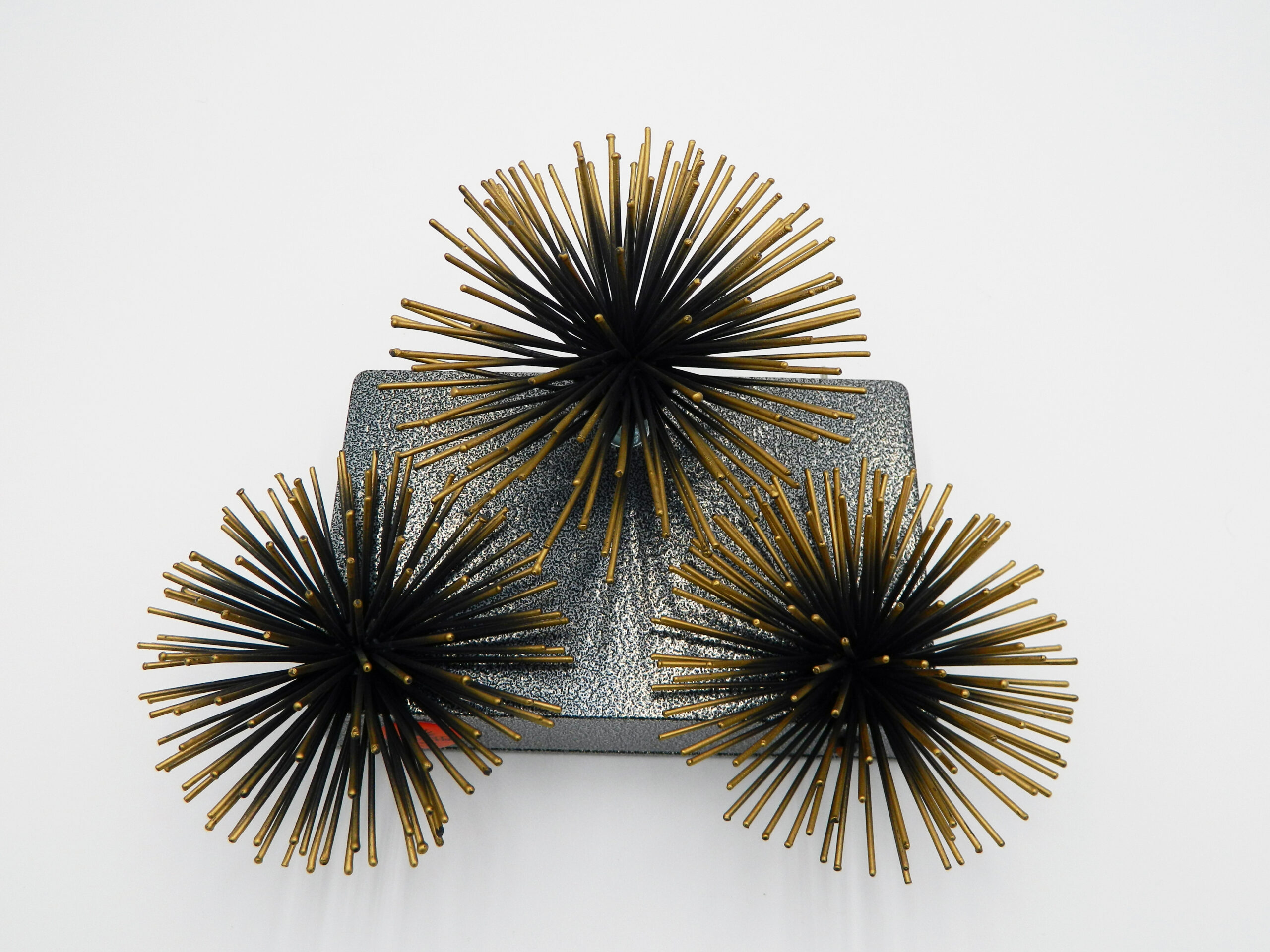 3 urchin like devices on top of an electrical device box, a sound instrument from a dream