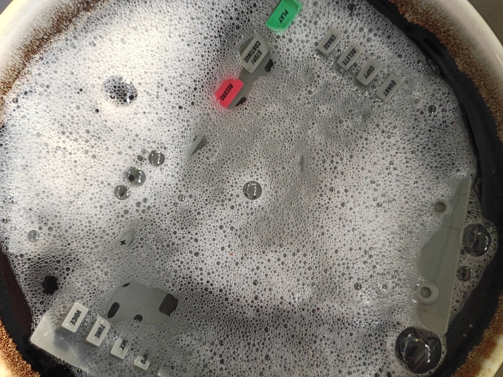 Washing the silicon button pad before conductive paint application.